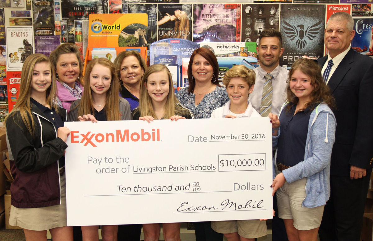 ExxonMobil recently gave Southside Junior High a $10,000 contribution to help with flood recovery efforts. Pictured from left to right are (front row) Southside Junior High Student of the Year nominees Savannah Bishop, Elle Denton, Kahner Boyer, Luke Turner and Hailey Pahnks, (second row) teachers Leanne Payne and Julie Vanzandt, ExxonMobil employee Rory Denicola, Southside Junior High Principal West Partin and Superintendent Rick Wentzel.