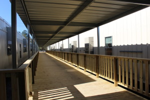 Covered decks will connect all the buildings at the new temporary campuses for Southside Elementary, Southside Junior High and Denham Springs Elementary, keeping students safe and dry as they move throughout the campus.  Pictured is the completed deck of the new Southside Elementary that runs between two classroom buildings.)