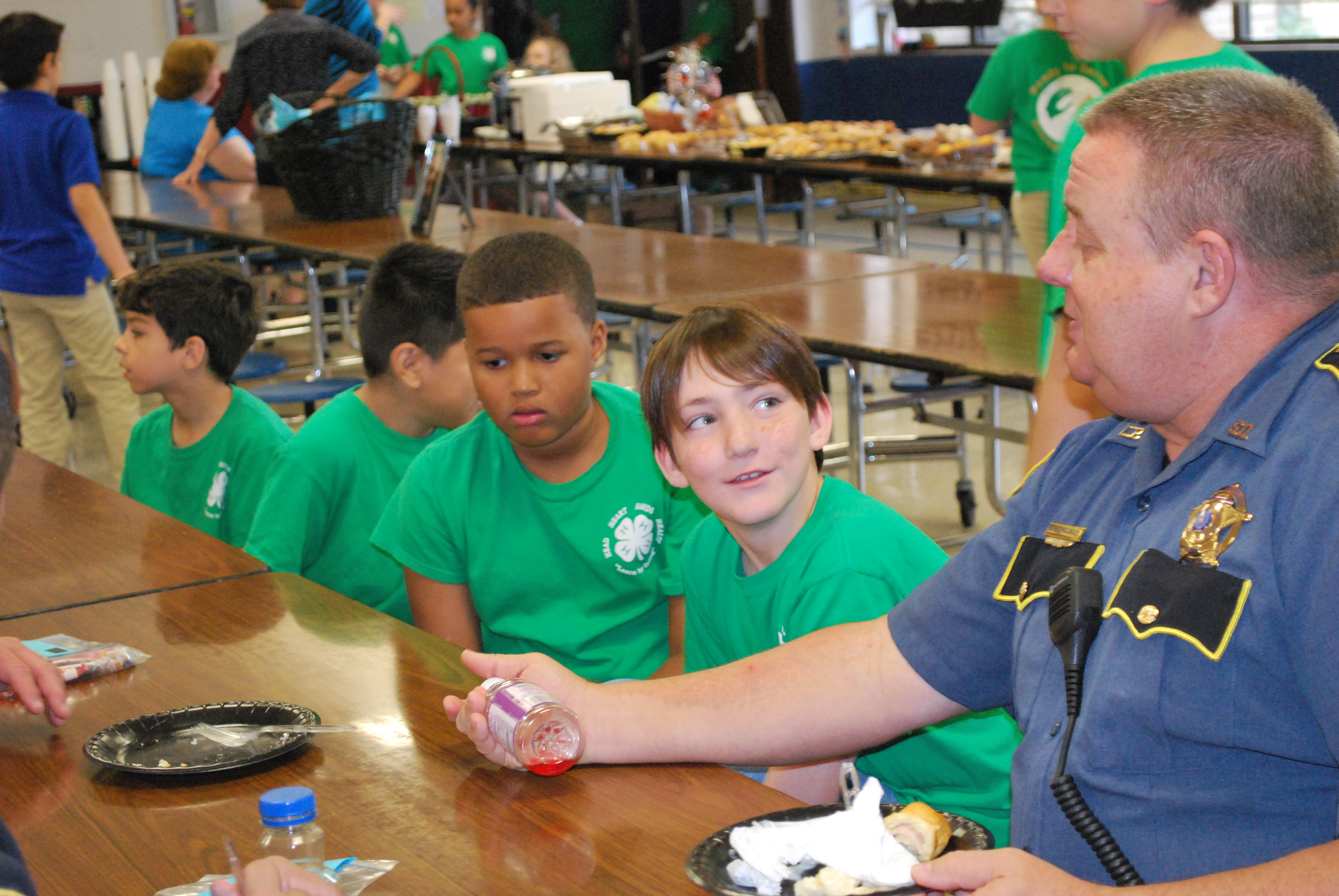Livingston Parish School Resource Officer Burley McCarter talks with Lewis Vincent Elementary students Blaine Parsons and Juelz Walters during a special “Back the Blue” Day breakfast at the school.